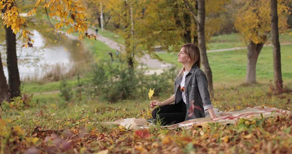 Attractive Woman Relaxing in Autumn Park