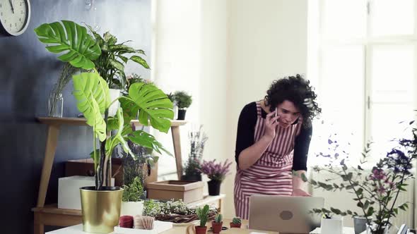 Florist discussing order with client on the phone