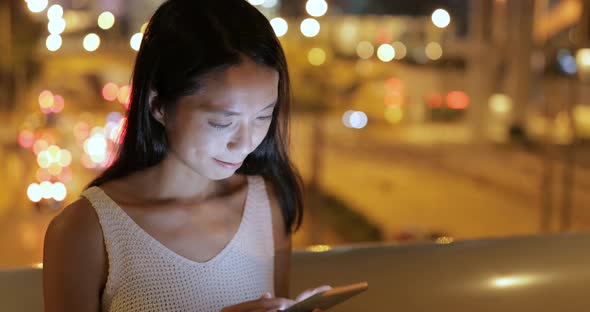 Woman use of mobile phone at night