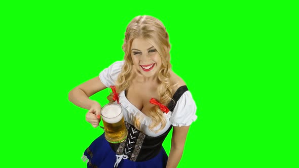 Girl in Bavarian Costume Drinking Beer and Shows the Thumb. Green Screen