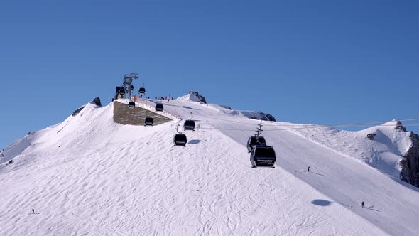 Ski Lift Moving Over Snowy Landscape in Austrian Alps