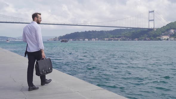 Business worker walking by the sea.