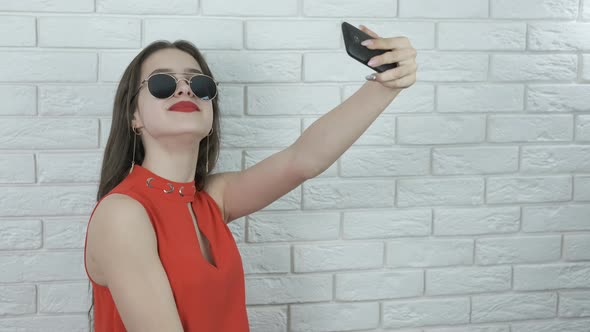 Girl model makes selfie.