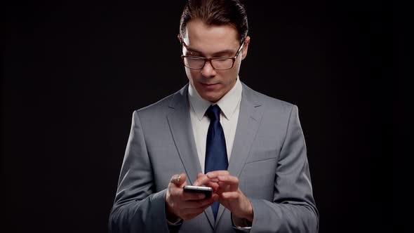 Studio portrait of successful and smart businessman in suit and tie.