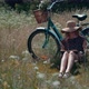 Woman Sitting On Flower Meadow And Reading Book Diary. Lady In Hat Enjoying Weekend On Holiday. - VideoHive Item for Sale