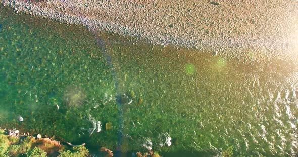 Low Altitude Flight Over Fresh Fast Mountain River with Rocks at Sunny Summer Morning.