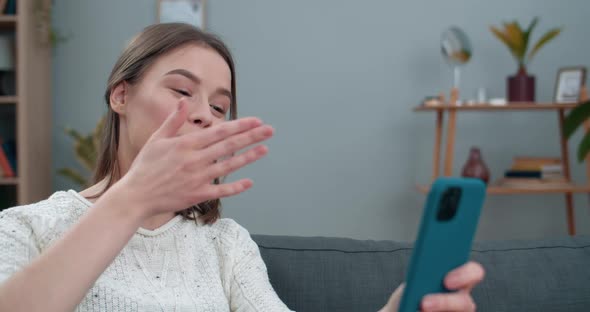 Crop View of Deaf Woman Having Video Conversation and Showing with Sign Language Phrase Hello, Tell