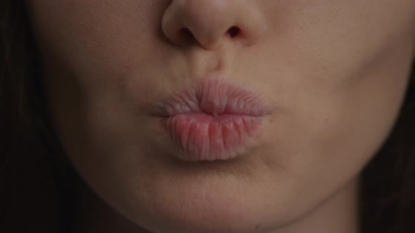 Close Up of a Caucasian Woman Lips Doing a Kiss and a Smile in Slow Motion