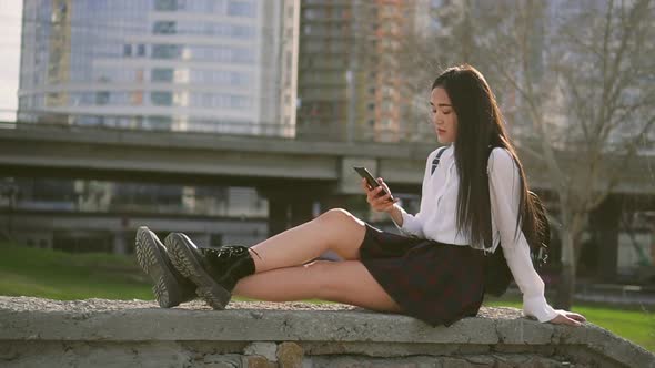 Chinese Cute Girl Is Chatting on Cell Phone