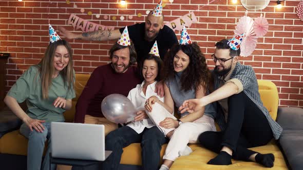 Group of People at Home Celebrating Birthday Wearing Party Hats Gasping in Surprise Having Video