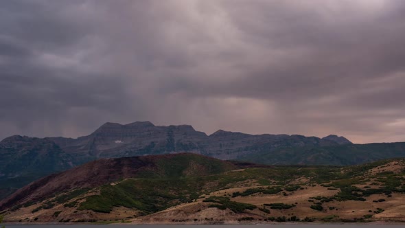 Time lapse of dark clouds moving over mountain range