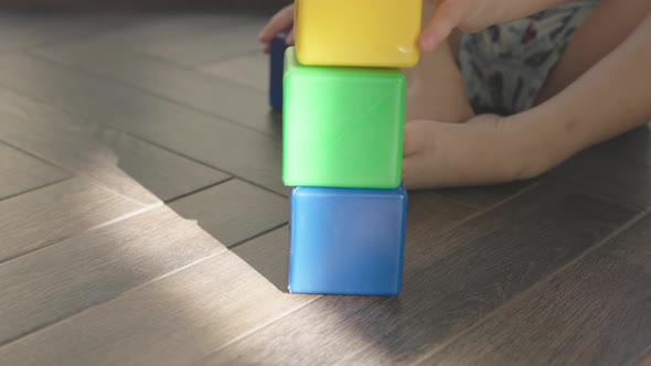 Child Playing Plastic Cubes Building Colorful Tower Kid Sitting on Floor Home