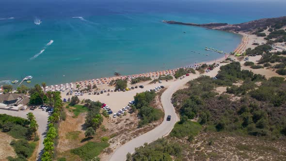 Car approaching Paradise Beach, Kos, ascending aerial shot