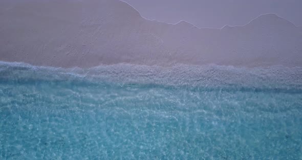 Natural overhead abstract shot of a sandy white paradise beach and aqua turquoise water background i