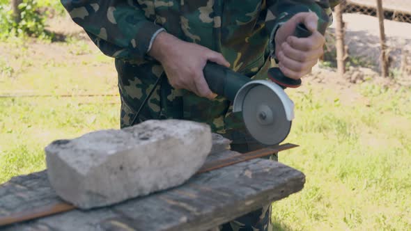 Close View Repairman Cuts Piece of Metal with Circular Saw