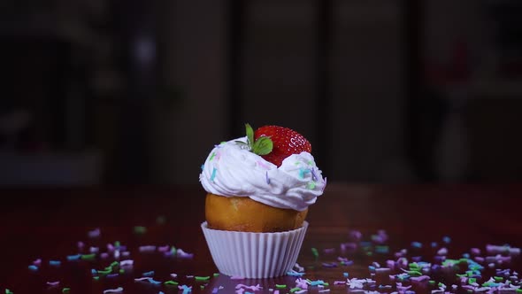 Strawberry Falls in Slow Motion on a Cake with Cream