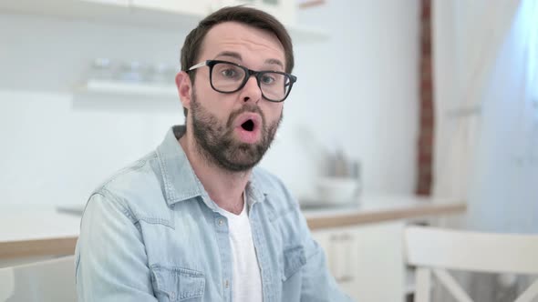 Attractive Beard Young Man Getting Shocked in Office 