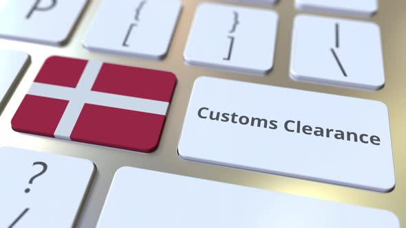 CUSTOMS CLEARANCE Text and Flag of Denmark on the Keyboard