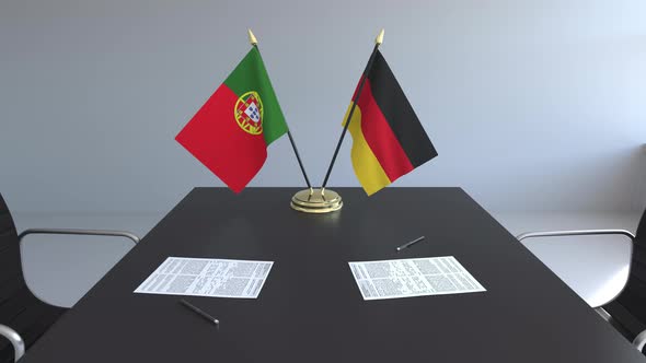 Flags of Portugal and Germany and Papers on the Table