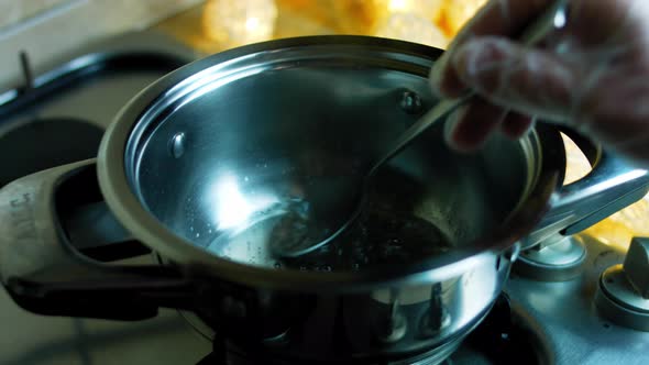 Mix the Sugar and Caramel Water with a Spoon