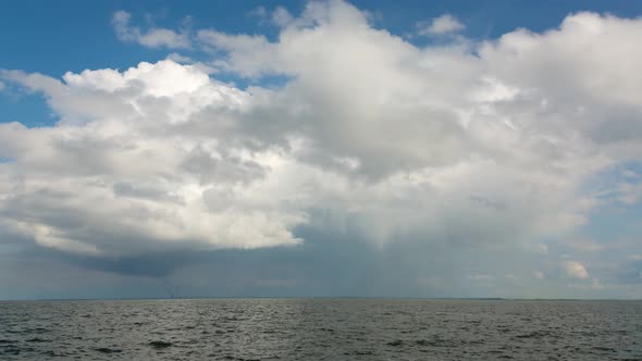 Large White Clouds With Rain Over The River, Time Lapse