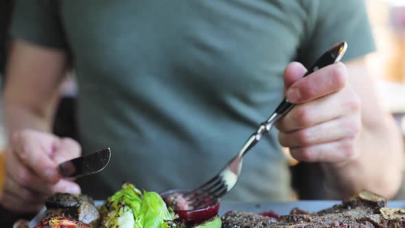 Man Eating Dinner In Restaurant. Closeup Man Eating Steak Meat