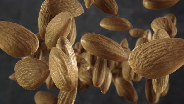 Flying of Almonds in Dark Kitchen Background