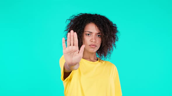 Pretty African Woman Disapproving with NO Hand Sign Gesture