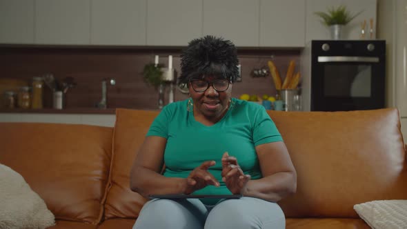 Senior Black Woman Chatting Online on Digital Tablet