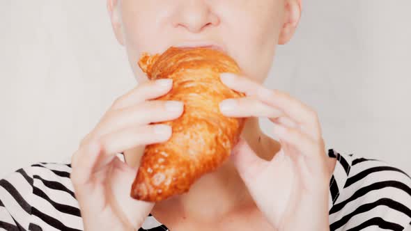 Portrait Caucasian Female Eats Croissant