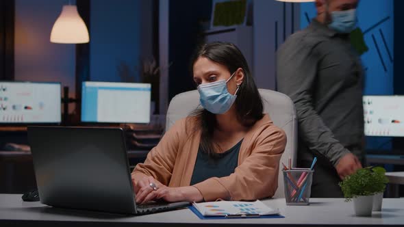 Workaholic Businesswoman with Face Mask Against Covid19 Working in Startup Office