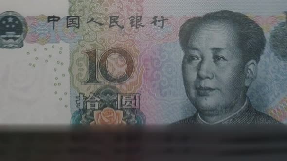 10 Chinese Yuan banknotes in cash machine.