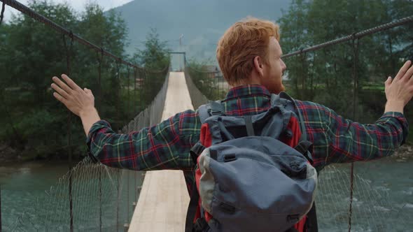 Backpacker Walk Bridge on Mountains River Closeup