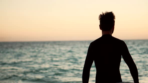 Professional Swimmer Training For Triathlon Competition In Open Water. Triathlete Silhouette.