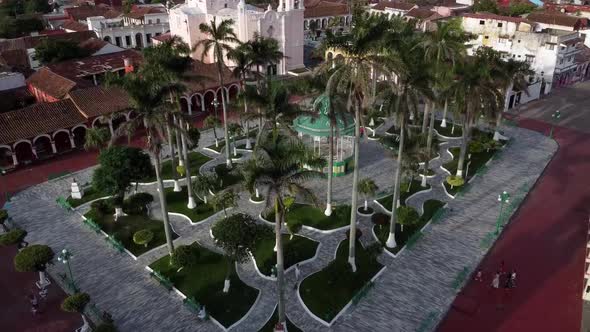 Tilt down drone shot of downtown Tlacotalpan with people walking, Veracruz