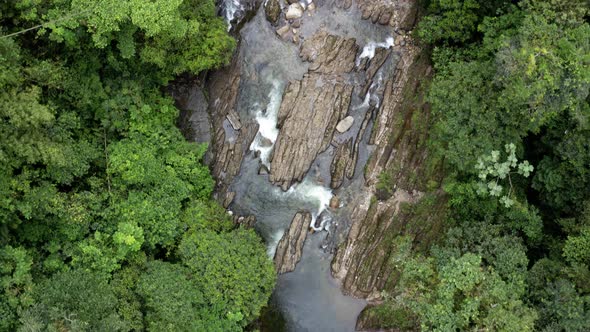 Aerial top view of a beautiful stream with many rocks lining the river