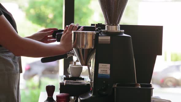 Close up shot of woman making coffee in restaurant from a professional coffee maker. Cafe Making Cof