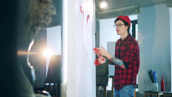 Male Painter is Creating a Picture with His Bare Hands