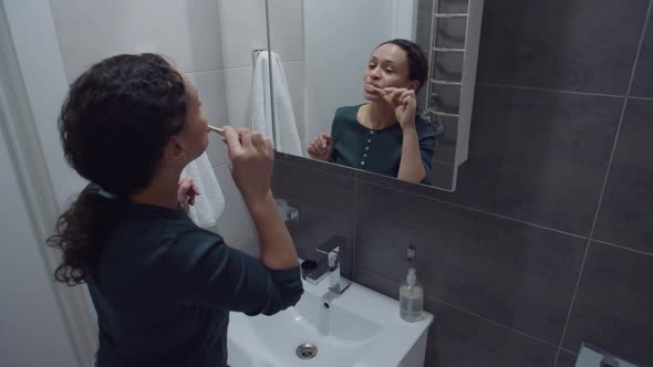 Black Woman Brushing Teeth Dancing Standing Front Mirror in Bathroom