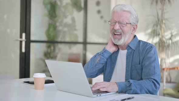 Senior Old Man Having Neck Pain While Using Laptop in Office