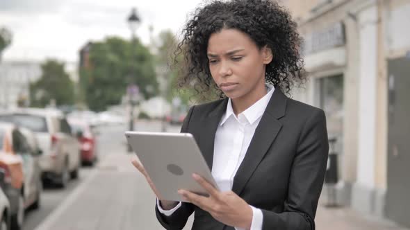 African Businesswoman Using Tablet Standing Outdoor on Footpath