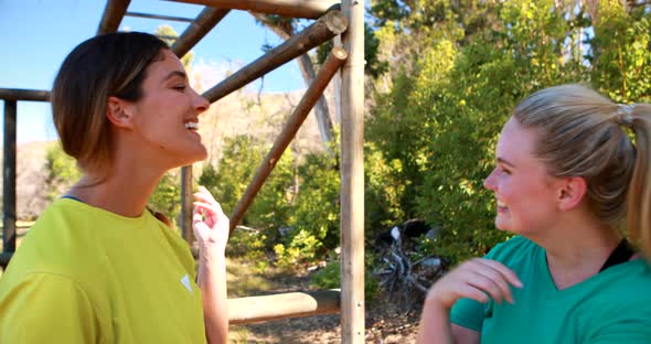 Happy friends interacting with each other during obstacle course