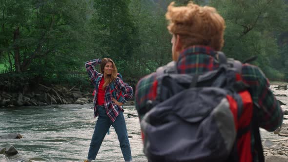 Photographer Taking Photos of Girl in Mountains