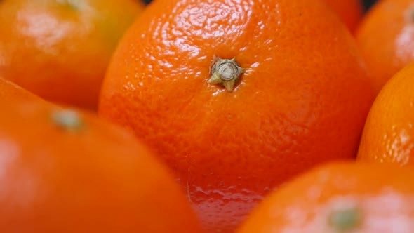 Lot of fresh tangerines on plate healthy fruit orange background 1080p FullHD video - Slow tilt on f