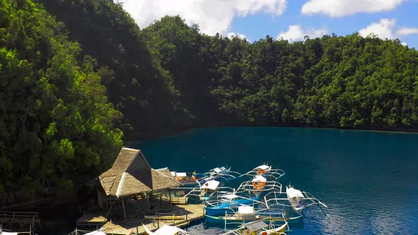 Aerial View Boat Pier in a Beautiful Tropical Bay on Sugba Lagoon in Siargao, Philippines.