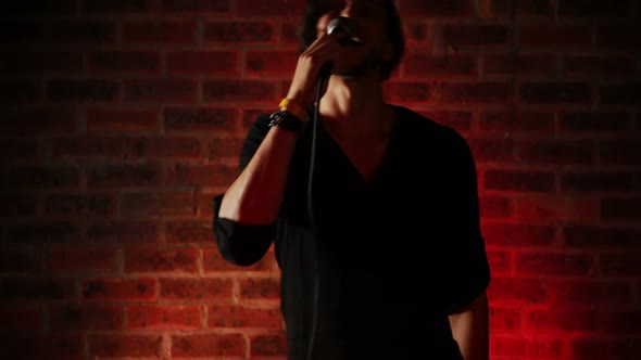 Male singer singing into a microphone