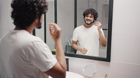 Hindu Man Fixes Hairstyle Pointing Fingers to Mirror