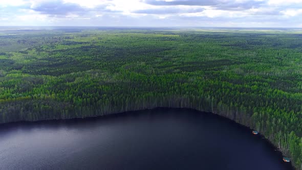 Flying above lake against the forests of spruce and pine trees, Drone collection