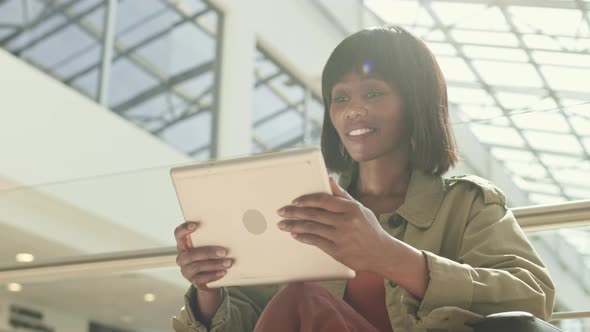 African Woman Having Video Call in Mall