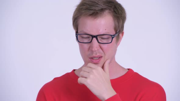 Face of Serious Young Man Thinking and Looking Down